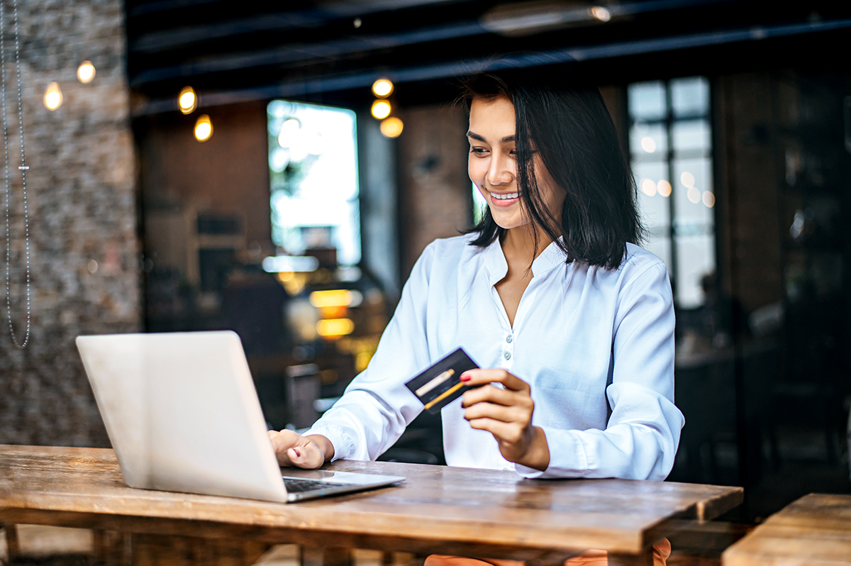 woman-sat-with-laptop-paid-with-credit-card